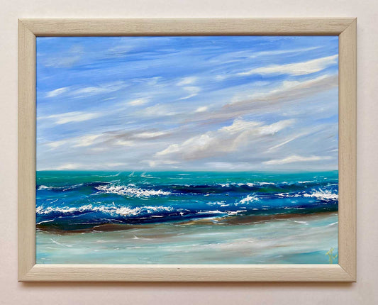 Framed painting of a seascape with blue sky and ocean. The waves are subtly textured.