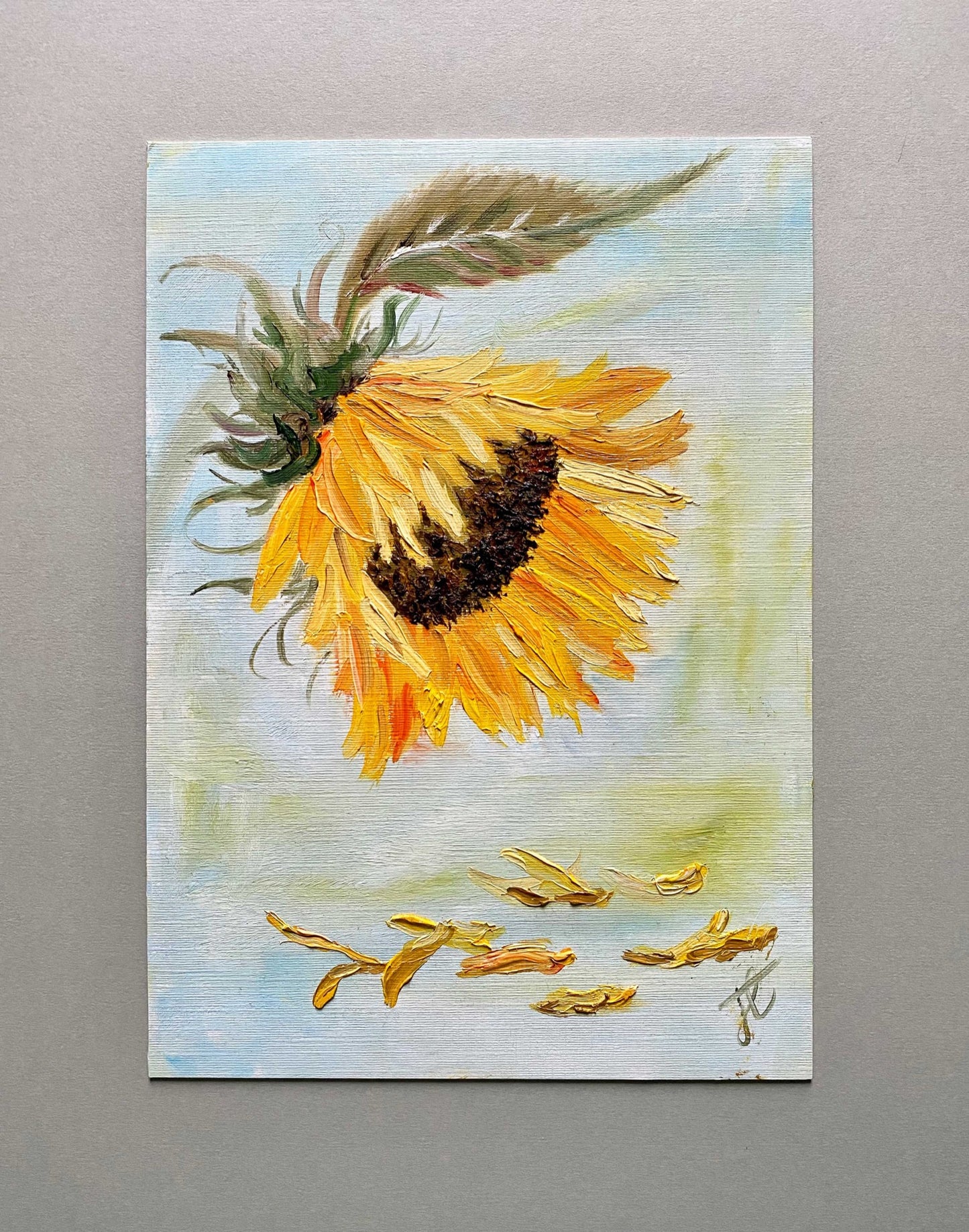 Painting study of sunflower bloom and leaf with dropped petals.