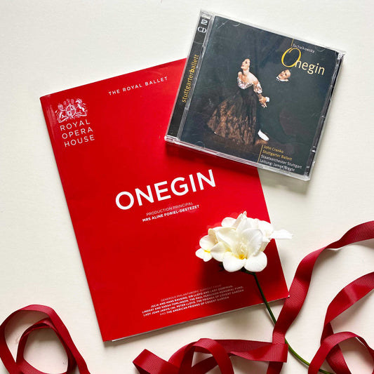 Onegin ballet score CD and red ballet programme photographed with white freesias and red ribbon