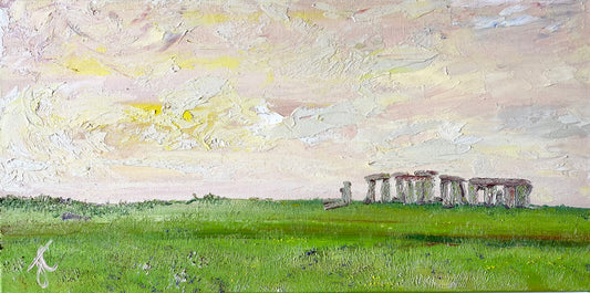 Panoramic format oil painting of English Heritage Stonehenge viewed across green meadow with sunset clouds in the sky. The henge is positioned to the right of the composition.