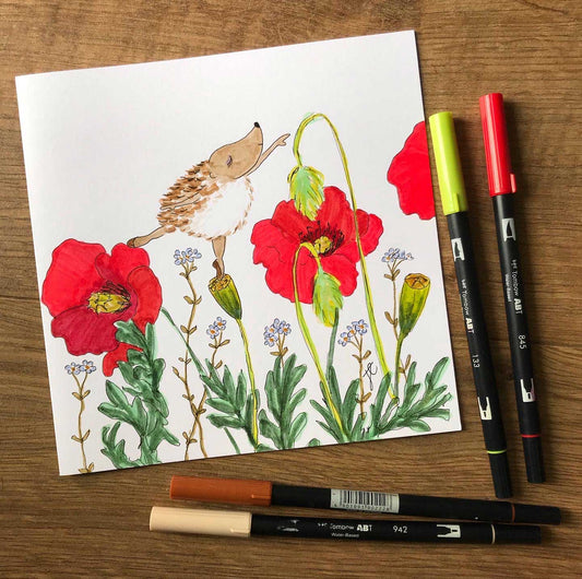 Ballettoons greetings card of Hedgie poised in arabesque balanced on garden poppies. Photographed with brush pens.