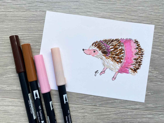 Drawing of hedgehog in pink wrap skirt shown with brush pens