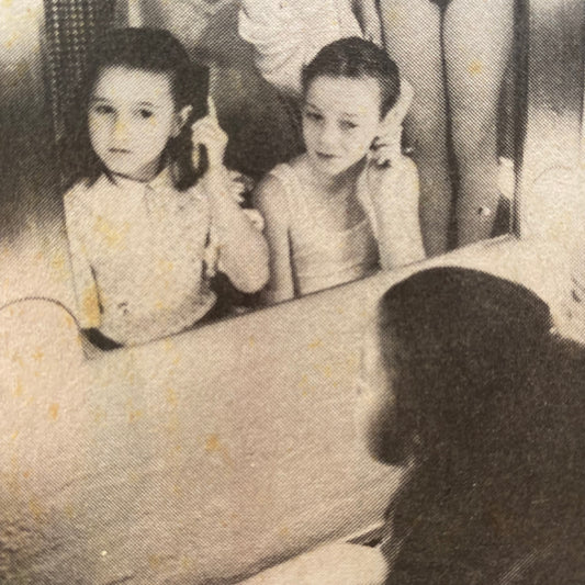 Detail from scan of newspaper cutting of young ballet dancers in front of dressing room mirror