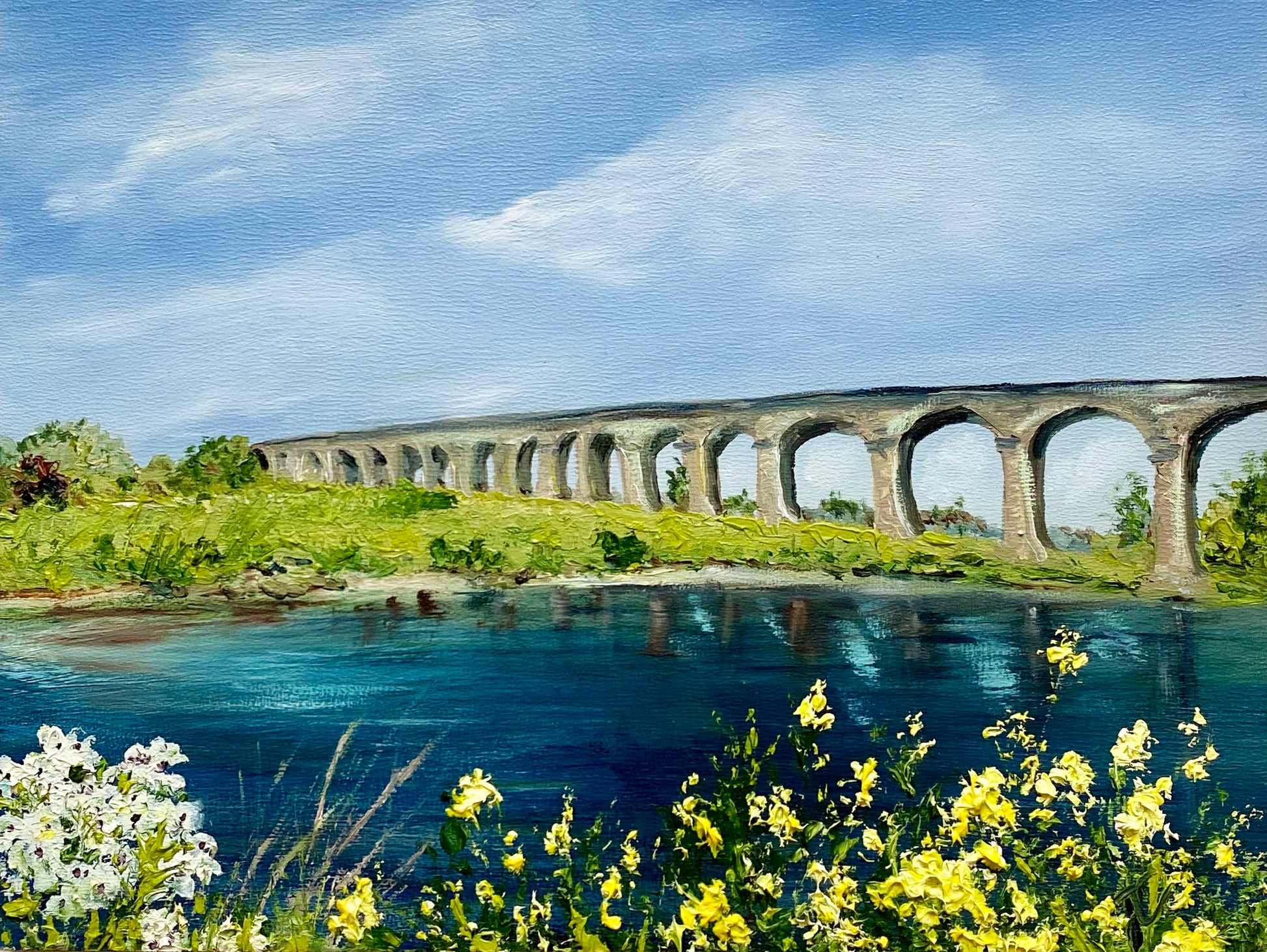 Landscape painting of viaduct viewed across river and textured flowers on the bank